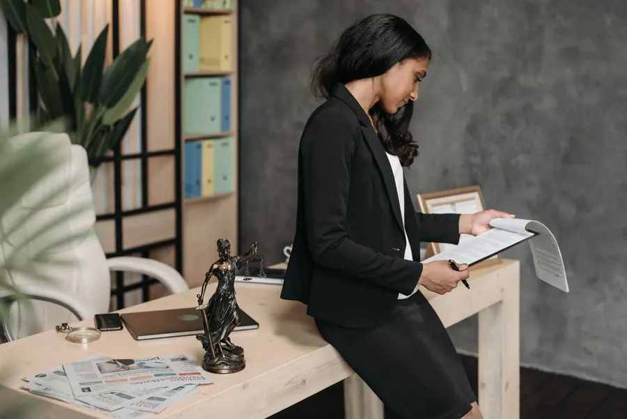 Attorney reviewing legal documents in her office